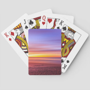 Zonsondergangslucht boven strand en zee pokerkaarten