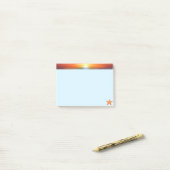 Zonsopgang en zeester op lichtblauw post-it® notes (Op bureau)