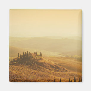 Zonsopkomst over een landschap in Toscane magneet