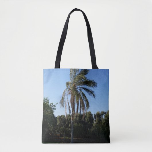 Zwaaiende palmboom onder een heldere hemel tote bag (Voorkant)
