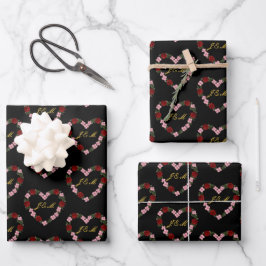 Zwart cadeaupapier met een roze en rode hart