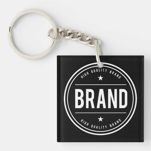 Zwart-wit cirkelvormig badge-logo sleutelhanger (voorkant)