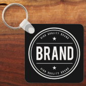 Zwart-wit cirkelvormig badge-logo sleutelhanger (Voorkant)
