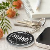 Zwart-wit cirkelvormig badge-logo sleutelhanger (Voorkant Rechts)
