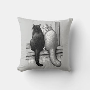 Zwart-witte katten bij het raam kussen