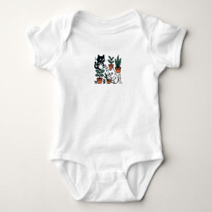 Zwart-witte katten tuinieren met planten romper