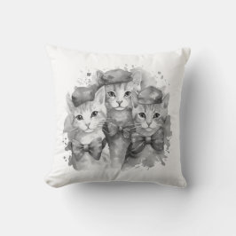 Zwart-witte kittens met strikken en petten kussen