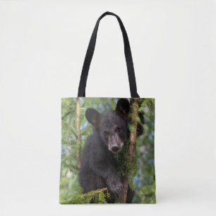 Zwarte beerwelp speelt in bomen tote bag