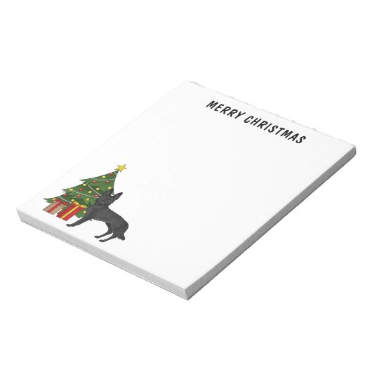 Zwarte Duitse herder en feestelijke kerstboom Notitieblok (Linkerzijde)