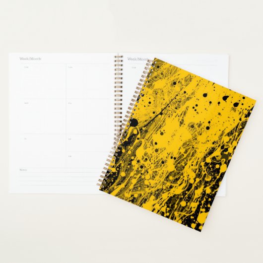 Zwarte en gele verfspatten planner (Display)