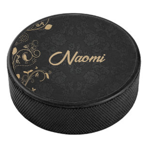 Zwarte en goudvogel hockey puck