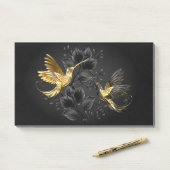 Zwarte en goudvogel post-it® notes (Op bureau)