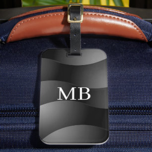 Zwarte en grijze gebogen vormen, wit monogram bagagelabel