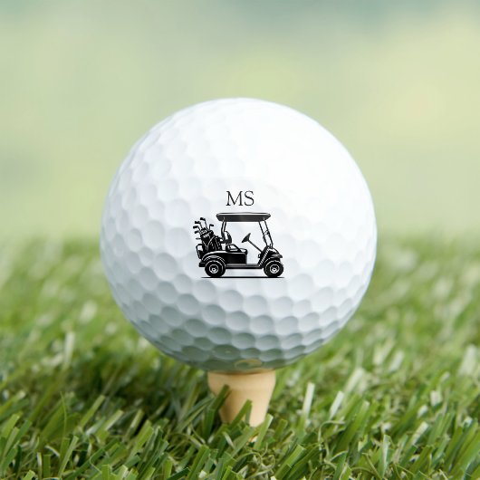 Zwarte en witte golfkar met initialen golfballen