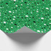 zwarte en witte sterren op groen cadeaupapier (Hoek)