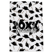 Zwarte gradatiekappen getoseerd in de lucht op wit medium cadeauzakje (Voorkant)