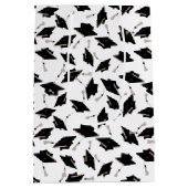 Zwarte gradatiekappen getoseerd in de lucht op wit medium cadeauzakje (Achterkant)