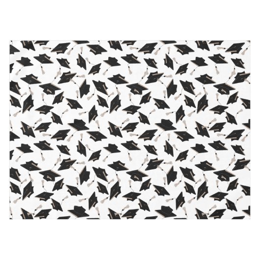 Zwarte gradatiekappen getoseerd in de lucht op wit tafelkleed (Voorkant (Horizontaal))