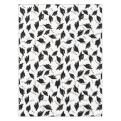 Zwarte gradatiekappen getoseerd in de lucht op wit tafelkleed (Voorkant)