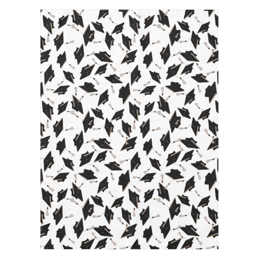 Zwarte gradatiekappen getoseerd in de lucht op wit tafelkleed (Voorkant)