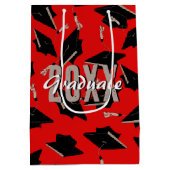 Zwarte gradatiekappen in de lucht op rood medium cadeauzakje (Achterkant)