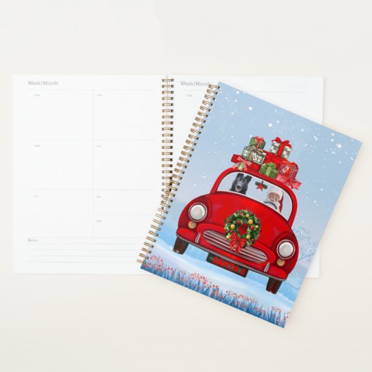 zwarte herderhond in auto met kerstman planner (Display)