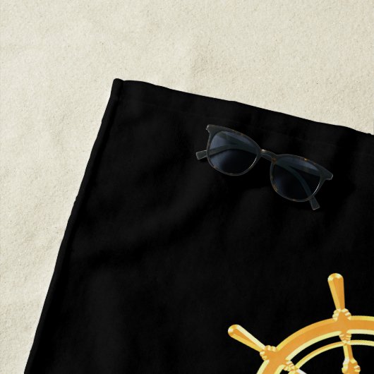 Zwarte jachtboot naam goud stuurwiel strepen strandlaken (In situ)