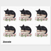 Zwarte kat knus slapend op boeken sticker (Vel)