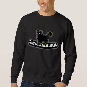 Zwarte kat op muziekpianoketoestel trui