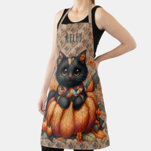 Zwarte kat op pompoen met herfstquiltpatroon schort