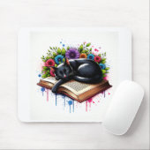 Zwarte kat slaapt op boek met bloemen muismat (Met muis)