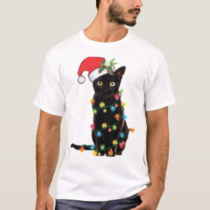 Zwarte kerstkat omhoog gedraaid in lichte kerstSan T-shirt
