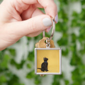 Zwarte kitten in kraag sleutelhanger (Hand)