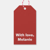 Zwarte kruisstift op rood cadeaulabel (Achterkant)