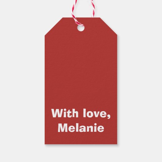 Zwarte kruisstift op rood cadeaulabel (Achterkant)