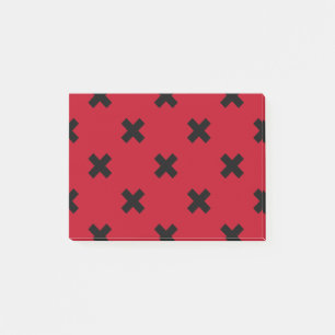 Zwarte kruisstift op rood post-it® notes