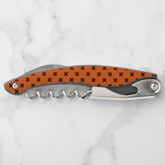 Zwarte kruisstiften op sinaasappel kurkentrekker (Achterkant)