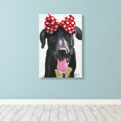 Zwarte labrador met rode bol aan kop canvas afdruk (Insitu (Houten vloer))