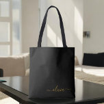 Zwarte naam Gold Girly Script Monogram Modern Tote Bag<br><div class="desc">Zwart en goudlegant Voeg je eigen monogram boekzak toe. Deze Book Bag kan worden aangepast om uw initiaal en voornaam op te nemen en wordt gegeven als cadeau voor Kerstmis,  Sweet 16 Birthday,  Vrijgezellenfeest of een bruiloft.</div>