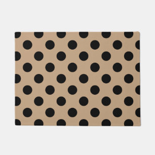 Zwarte polka-punten op beige deurmat