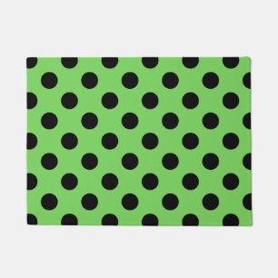 Zwarte polka-stippen op kalkgroen deurmat