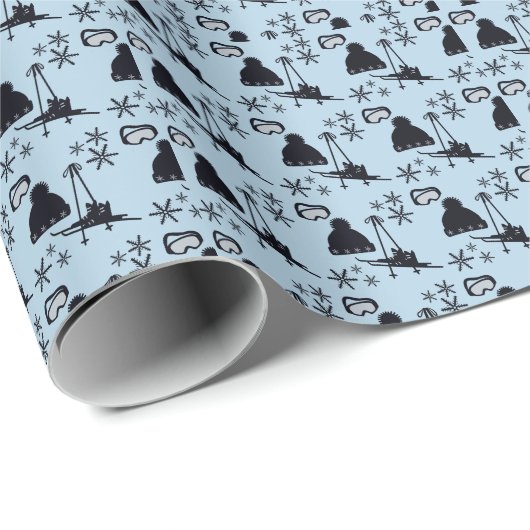 Zwarte ski-uitrusting & sneeuwvlokken op blauw cadeaupapier (Rol Hoek)