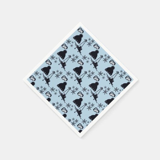 Zwarte ski-uitrusting & sneeuwvlokken op blauw servet (Hoek)