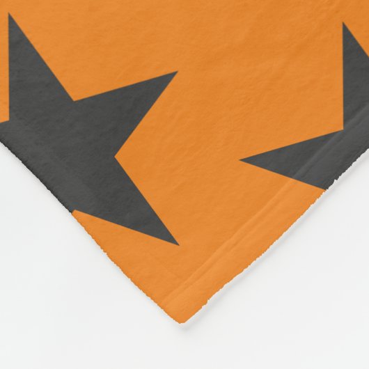 Zwarte sterren op pompoen fleece deken (Hoek)