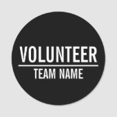 Zwarte Volunteer Badge met de naam van het Team va (Voorkant)