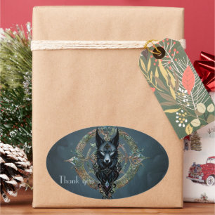 Zwarte wolfskop met doordringende blauwe ogen, ovale sticker