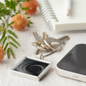 Zwarte zwaartekracht sleutelhanger (Zijkant)